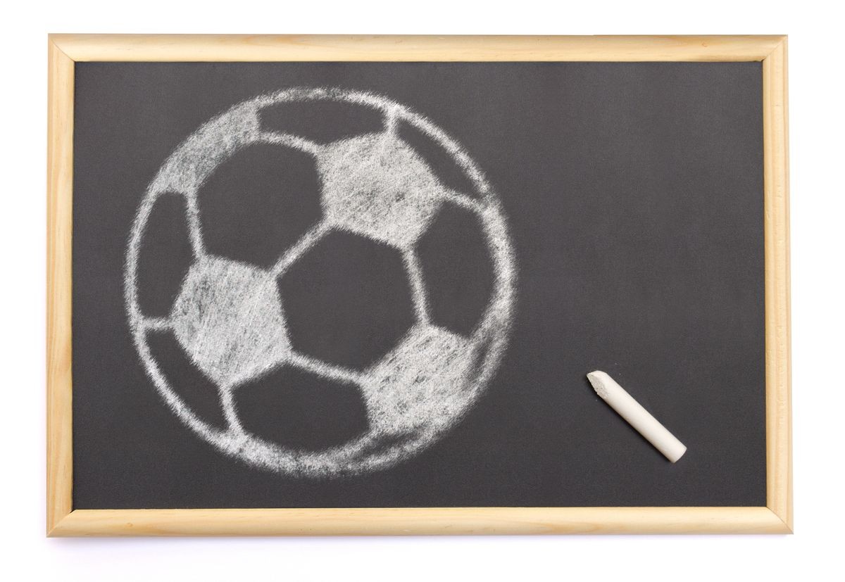 Small Blackboard with a chalk and the shape of a soccer ball drawn onto. (series)